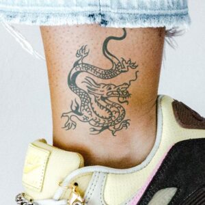 small dragon semi-permanent tattoo on girl's ankle, nike air max pink and goldtrainers, removable halal black jagua henna tattoo