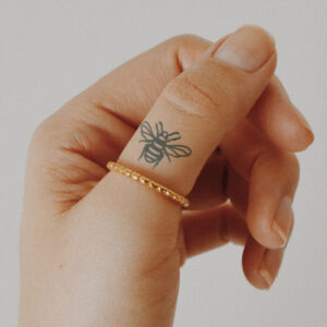tiny honey bee semi-permanent tattoo on thumb, removable halal black jagua henna tattoo