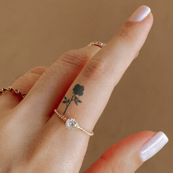 black rose with stem finger tattoo on woman's hand, semi-permanent tattoo, removable halal black jagua henna tattoo